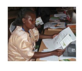 Veronica Gitahi, a GBM field facilitator, studies her training materials.