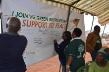 Participants at the event pledge their support for peace